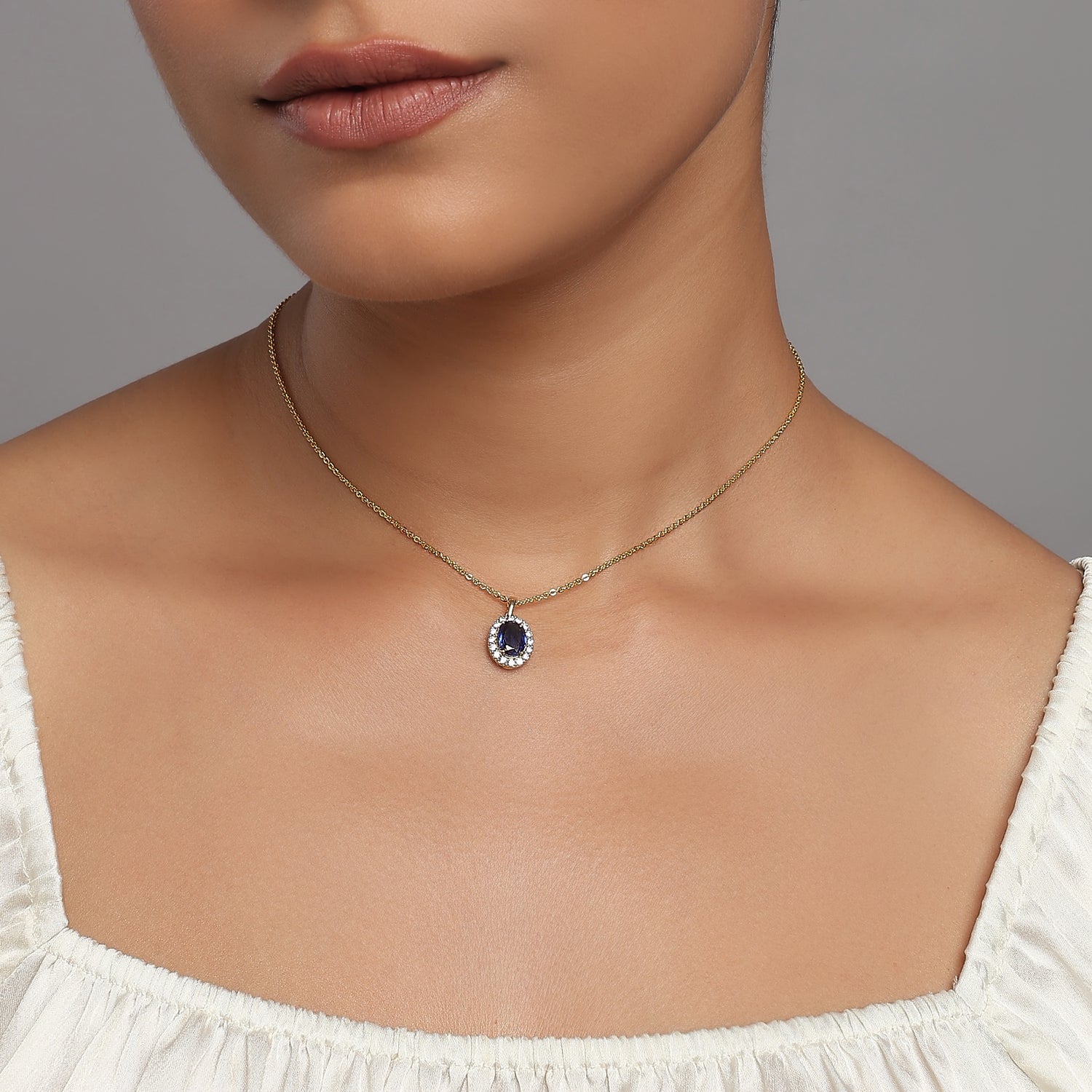Elegant Oval Halo Pendant Featuring A Radiant Deep Blue Center