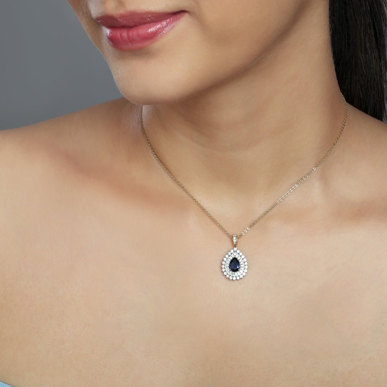 A Regal Teardrop Halo Pendant with Timeless Radiance